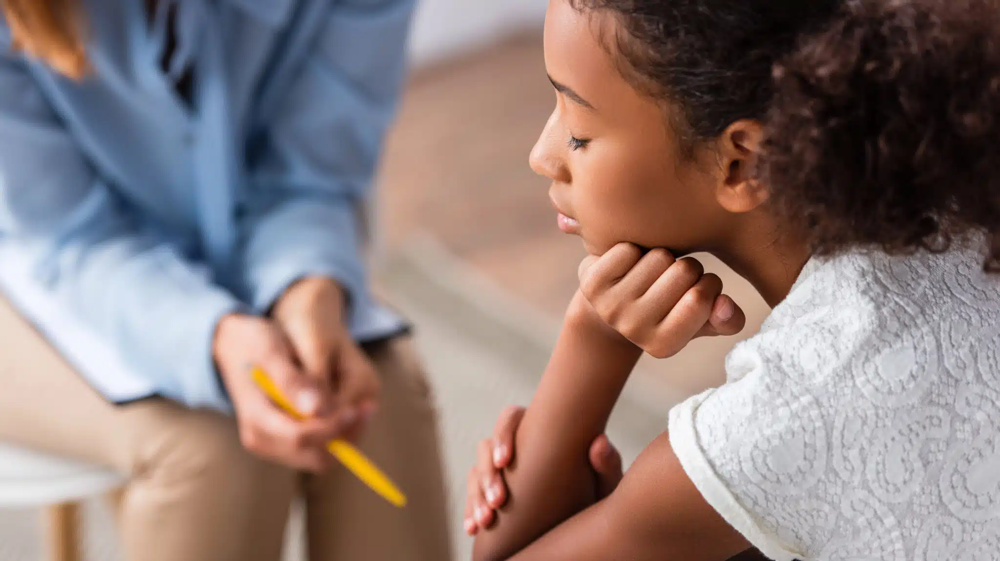 A young girl talks to a therapist - Youth Mental Health Rates In Massachusetts Prevention & Treatment Options