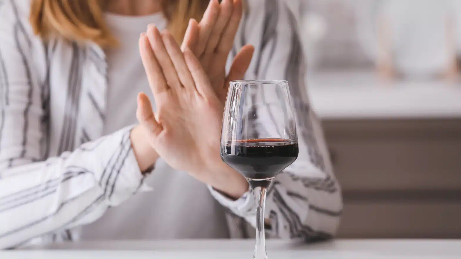 A woman crosses her hands to refuse a glass of wine - Antabuse (Disulfiram) For Alcohol Addiction Treatment In Massachusetts