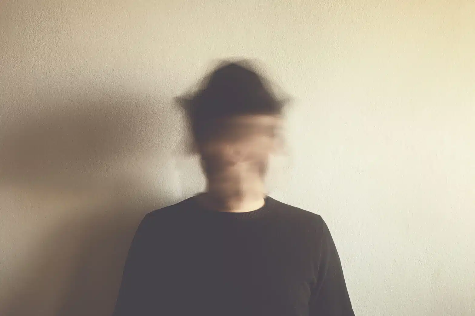A man stands alone, his face and head is highly blurred -Schizophrenia Overview & Treatment